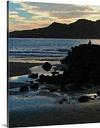 A figure meditates on a cliff overlooking the sea in Mazatlan